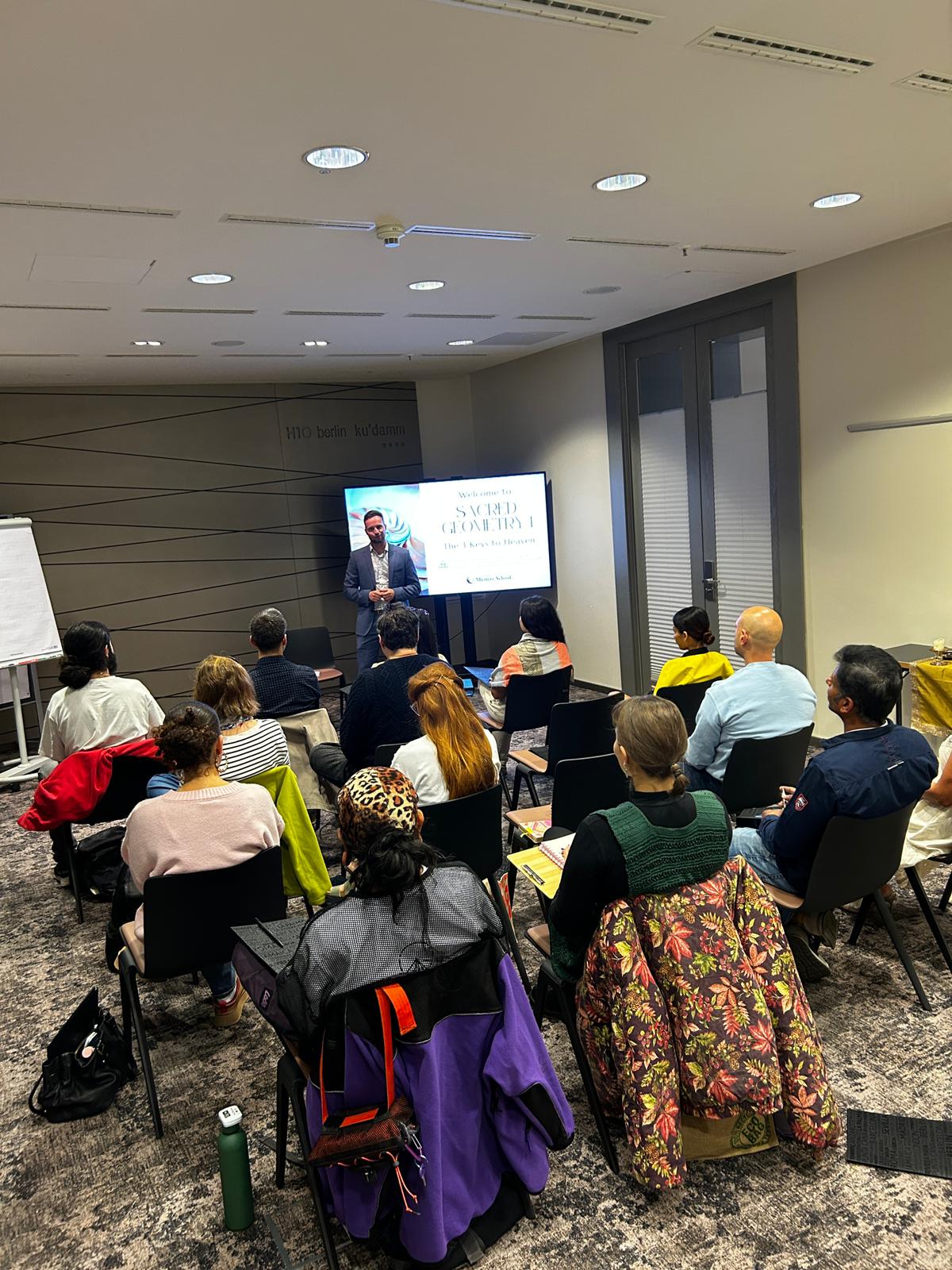 Sacred Geometry workshop in progress with presenter and engaged audience