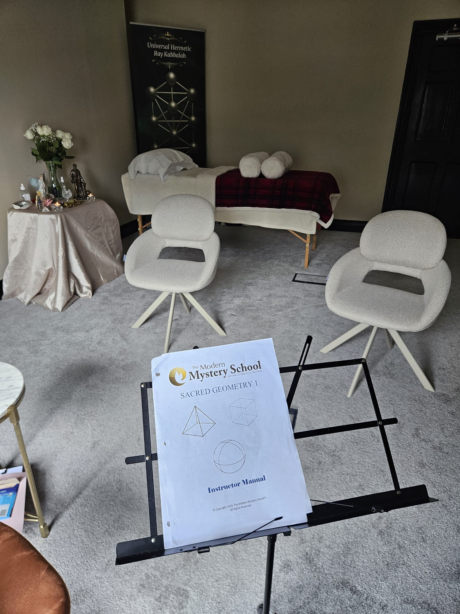 The sacred space set up with the Sacred Geometry 1 manual and Universal Hermetic Ray Kabbalah banner