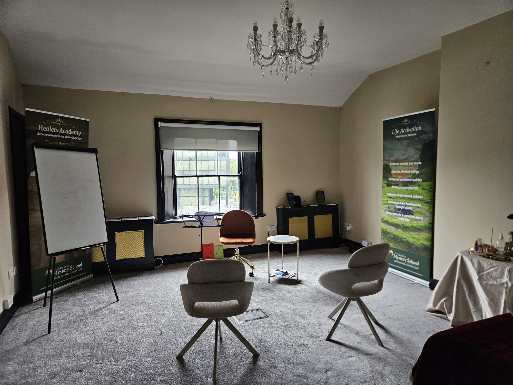 The workshop room at Ériu in Dublin, with seating arranged for the class and Modern Mystery School banners